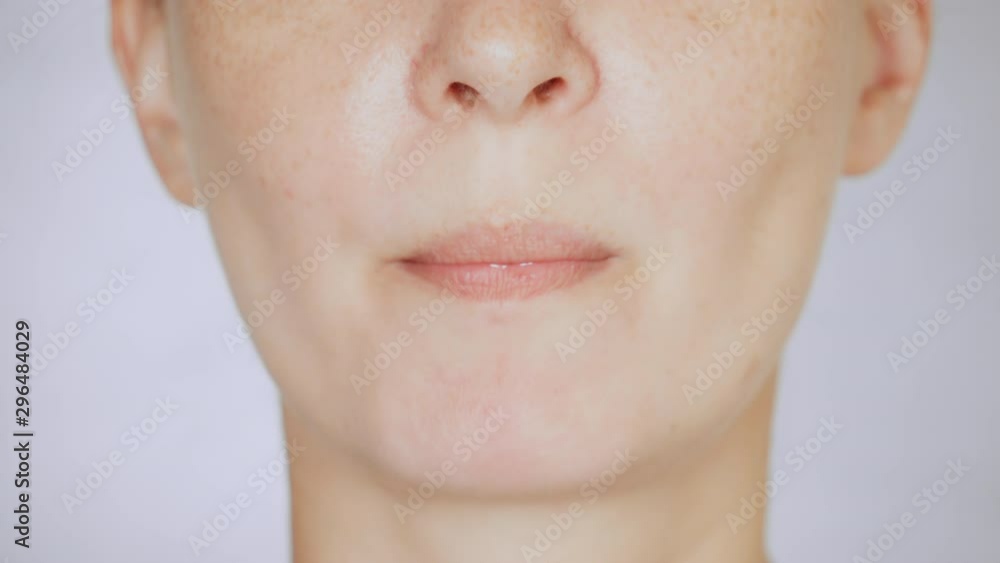 lower face caucasian female with freckles eats red tomato portrait lady bites and chews lower face caucasian female with freckles eats red tomato portrait lady bites and chews
