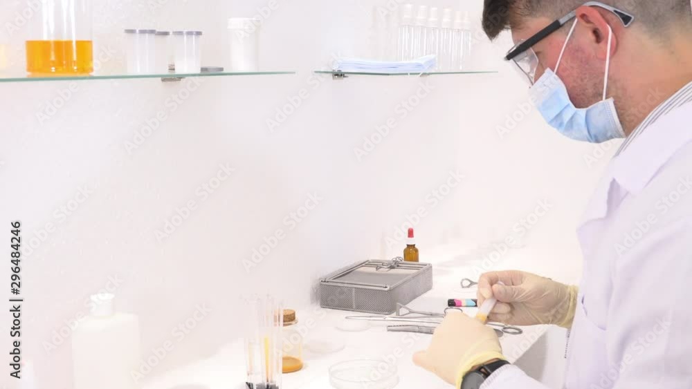 Pharmaceutical lab employee analyzes chemicals Pharmaceutical lab employee analyzes chemicals
