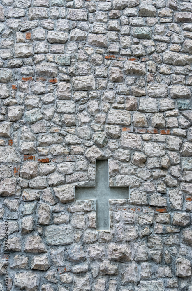 Grey stone wall background with shaped cross.