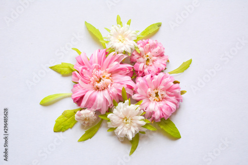 Beautiful light tender floral arrangement with pink and white flowers and green leaves. Flat lay, copy space, top vie 