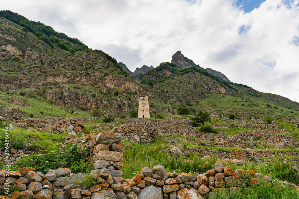 beautiful landscape, the old stone tower and a ruined city in a mountain valley
