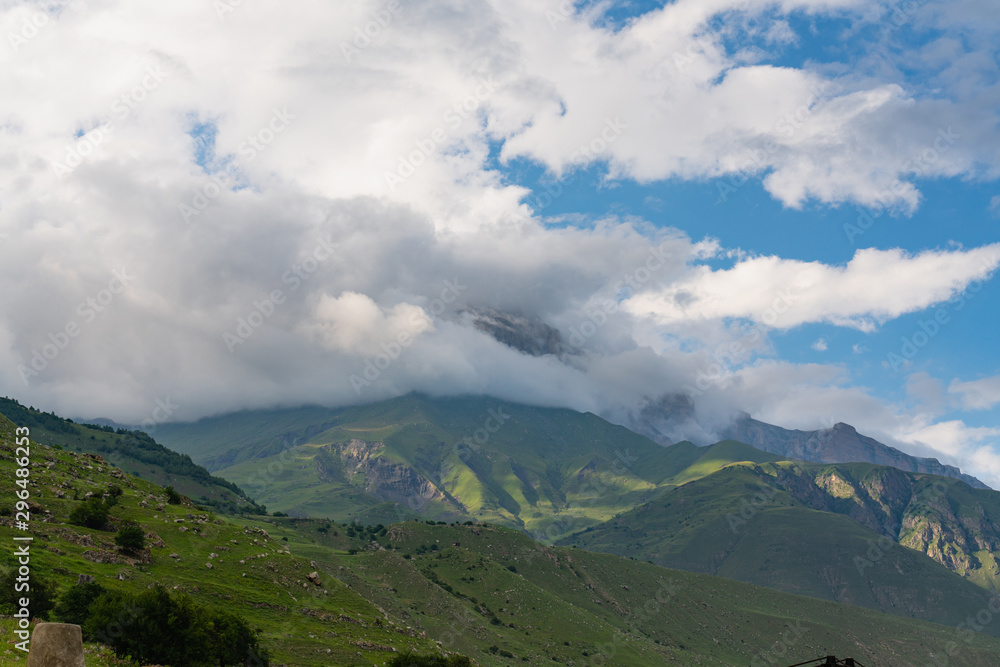 Obraz premium beautiful mountain landscape on a bright Sunny day with blue sky and white clouds.