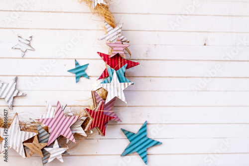 .Star christmas wreath in soft colors over white wooden table with copy space. Minimalist Christmas Decoration