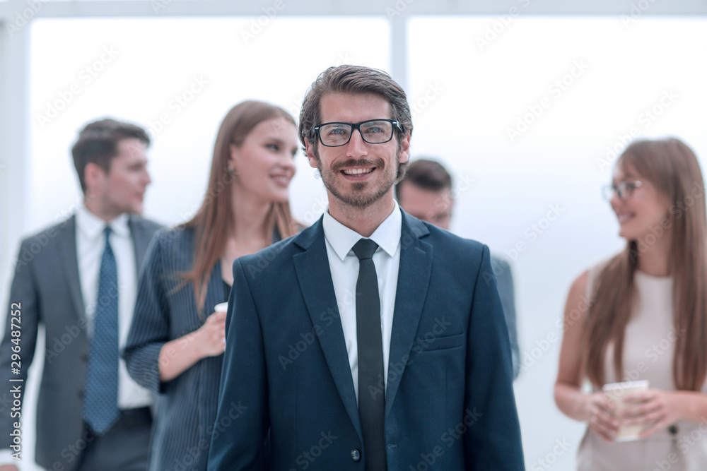 successful young businessman standing in the office successful young businessman standing in the office