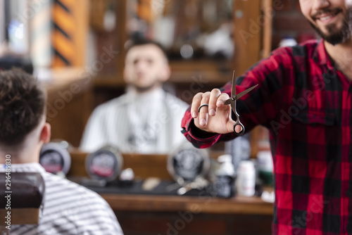 Barber holding scissors in his right hand