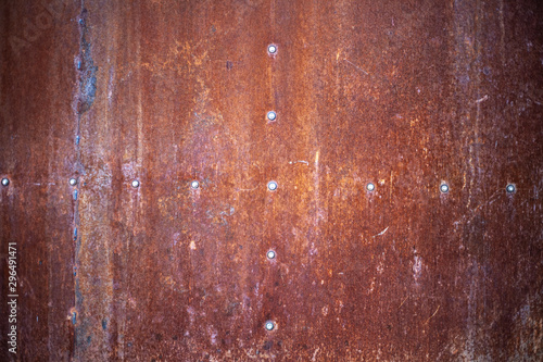 Rusty texture. Rusty metal background. Through a rusted metal sheet.