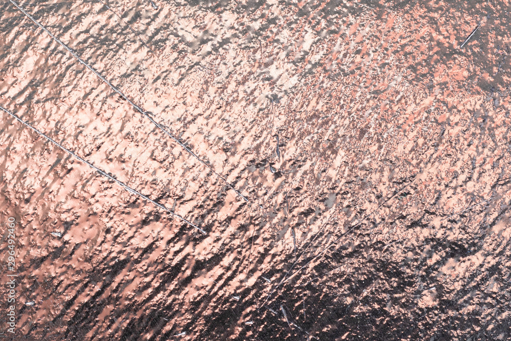 Obraz premium Golden reflective texture for background. Sheet of foil surface scratches and dark shadows