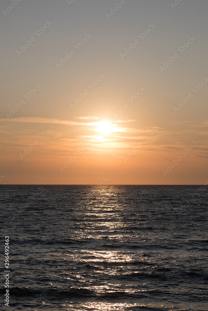 Dark sea surface with waves and sun reflection