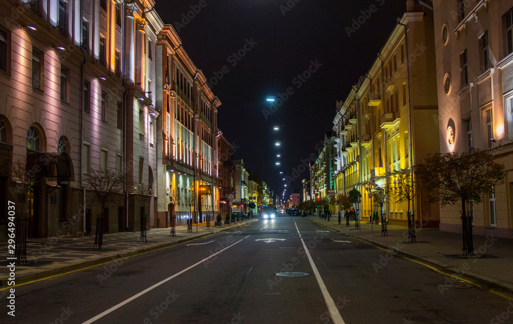 Night city with luminous streets. Buildings with beautifully colored lights.