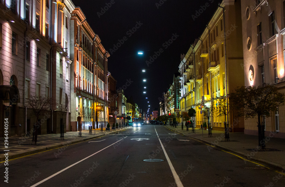 Night city with luminous streets. Buildings with beautifully colored lights.