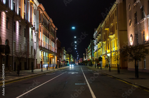 Night city with luminous streets. Buildings with beautifully colored lights. © Payllik