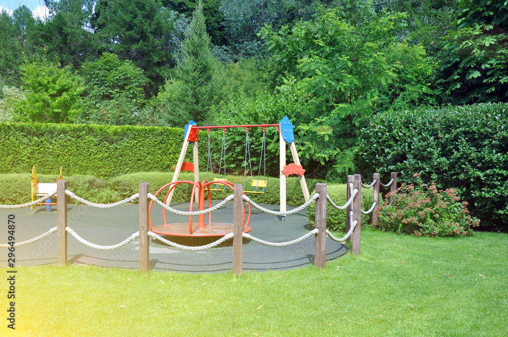Playground for children in the park among the green trees. Playground for children in the park among the green trees.