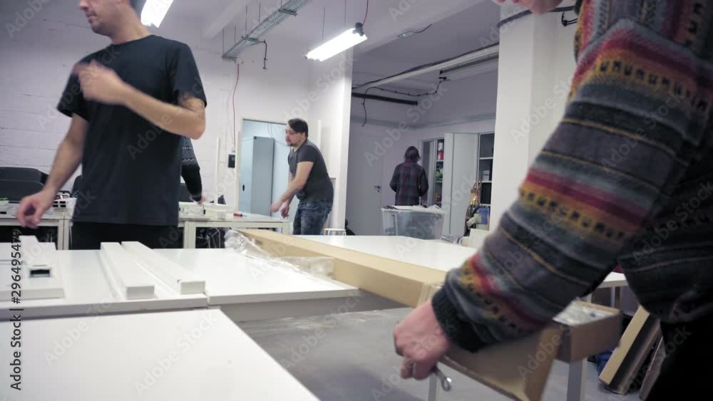 Men assembling new office desks Men assembling new office desks
