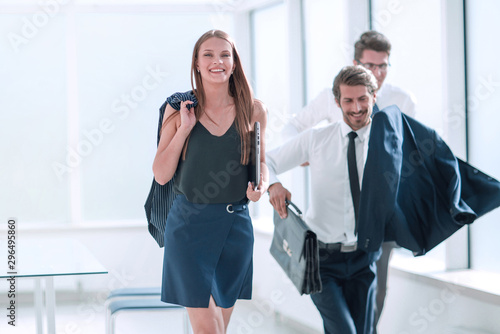 cheerful employees completing their work day at the office