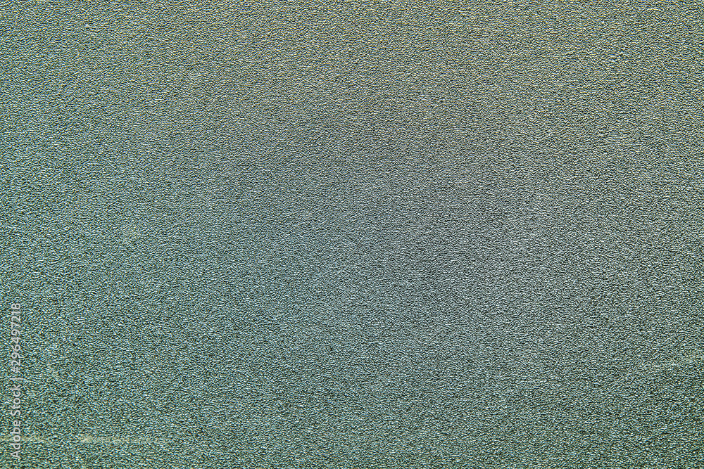 Fototapeta premium Wall of gray granular material as a background