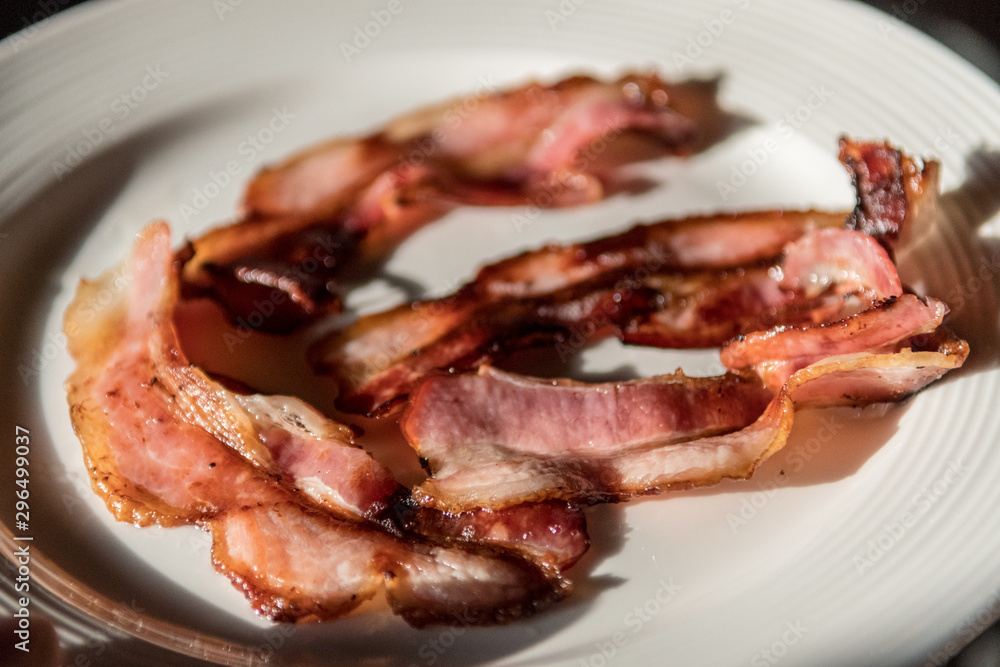 Isolated close up plate of delicious fried bacon