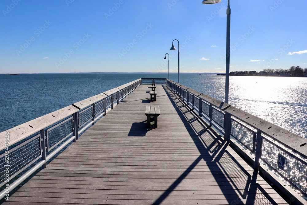 View along pier in winter with blue sky
