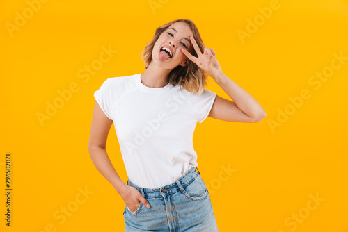 Image of funny blond woman in basic t-shirt showing peace fingers