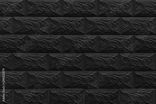 Black decorative wall made of brickwork background texture.