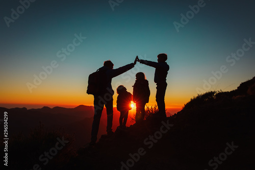 family with kids travel in sunset mountains, parenting concept