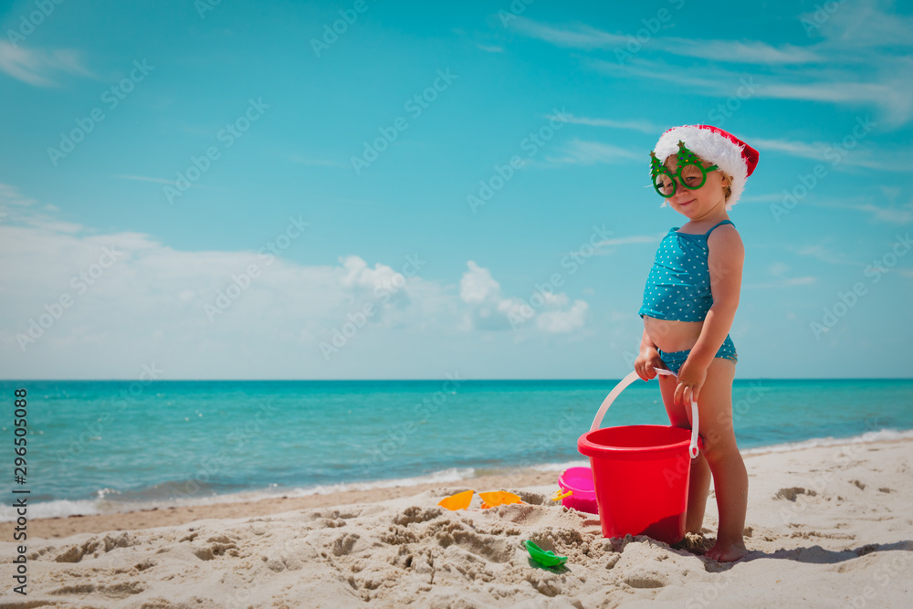 cute little girl celebrating christmas on tropical beach cute little girl celebrating christmas on tropical beach