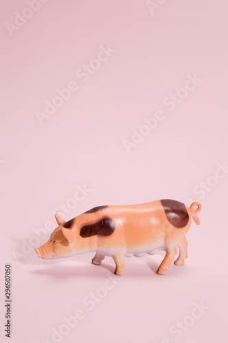 pig plastic figurine pink background