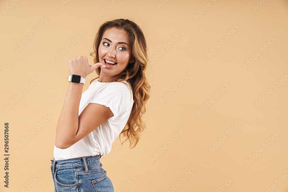 Portrait of beautiful woman smiling and pointing finger at copyspace Portrait of beautiful woman smiling and pointing finger at copyspace