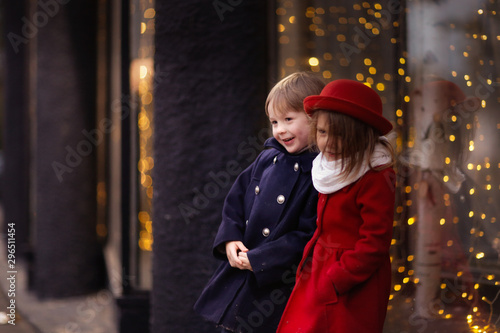 funny couple of children hug, Christmas lights