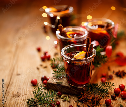 Obraz na plátne Christmas mulled red wine with spices and citrus fruits on a wooden rustic table, copy space