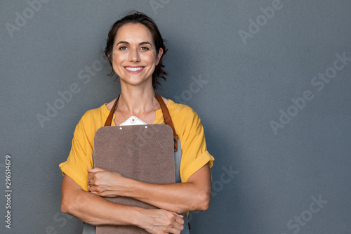 Woman entrepreneur in apron looking at camera