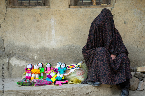 Iranian woman selling hand made dolls for tourists in village of Masuleh, Gilan, Iran photo