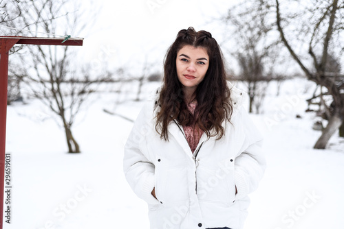  brunette in white jacket and warm gloves having fun