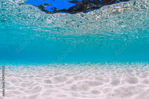 Tropical transparent ocean with white sand underwater