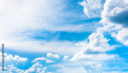 Fluffy bright white clouds with a beautiful clear blue sky ozone and background sunshine in the summer morning.