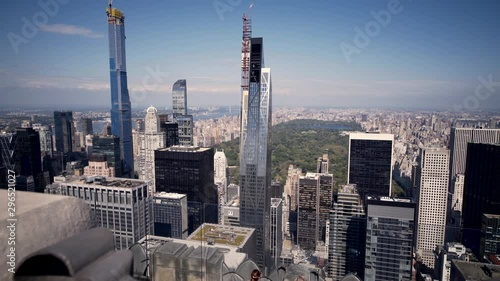 Camera moves across the railing of the Rockefeller Center Observation Deck to give a view of Manhattan with Central Park