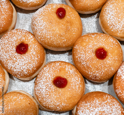 Fresh donuts  with jelly  at the bakery display for Hanukkah celebration. Selective focus. photo