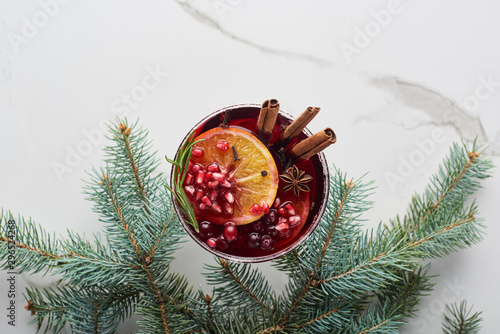 top view of christmas cocktail with orange, pomegranate, cinnamon