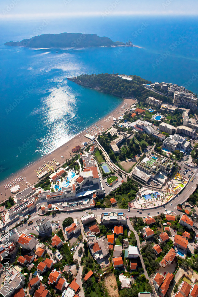 City resort with hotels and pools. landscape below (aerial photo from a paraglider) with the coast and the blue sea, Montenegro