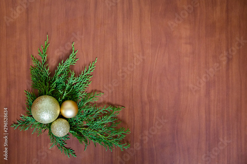 Christmas wooden background with fir branches and balls. New Year's decoration.