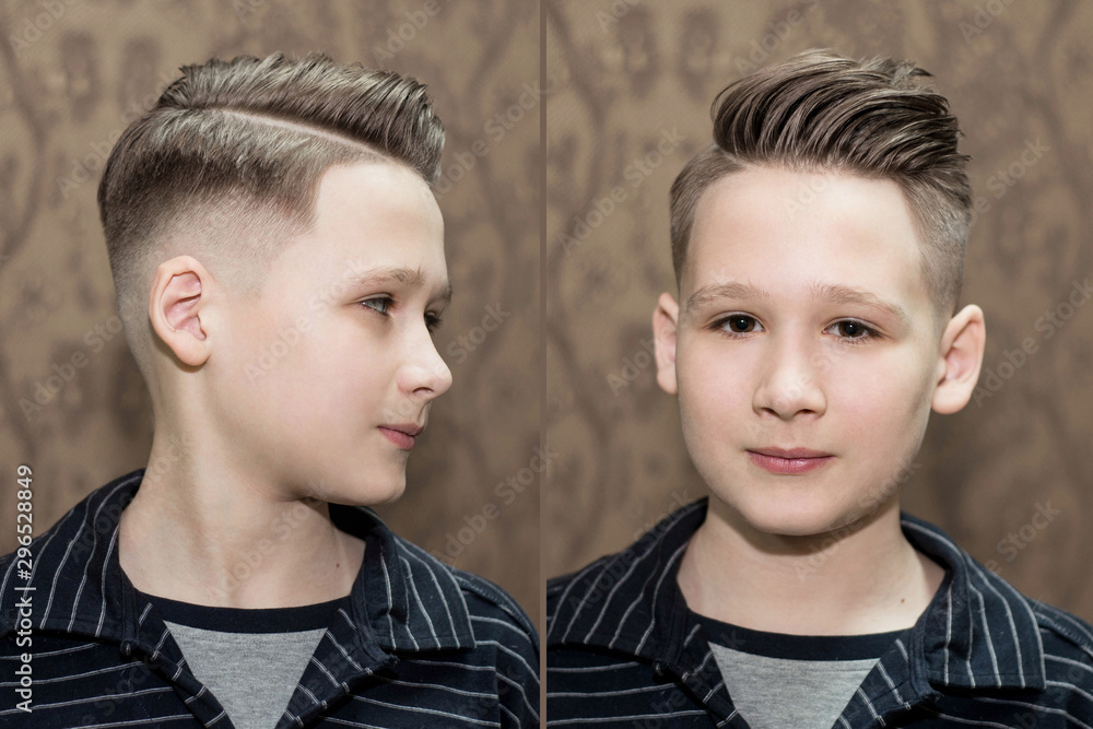 Fototapeta premium Stylish modern retro haircut side part with mid fade with parting of a school boy guy in a barbershop on a brown background