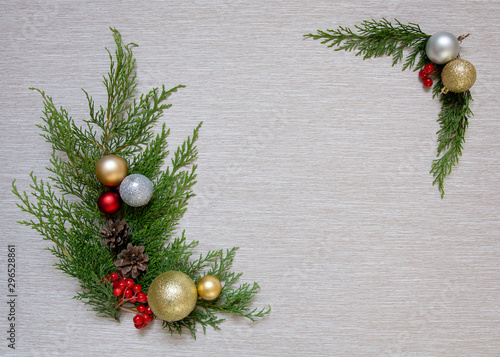 Christmas wooden background with fir branches and balls. New Year's decoration.