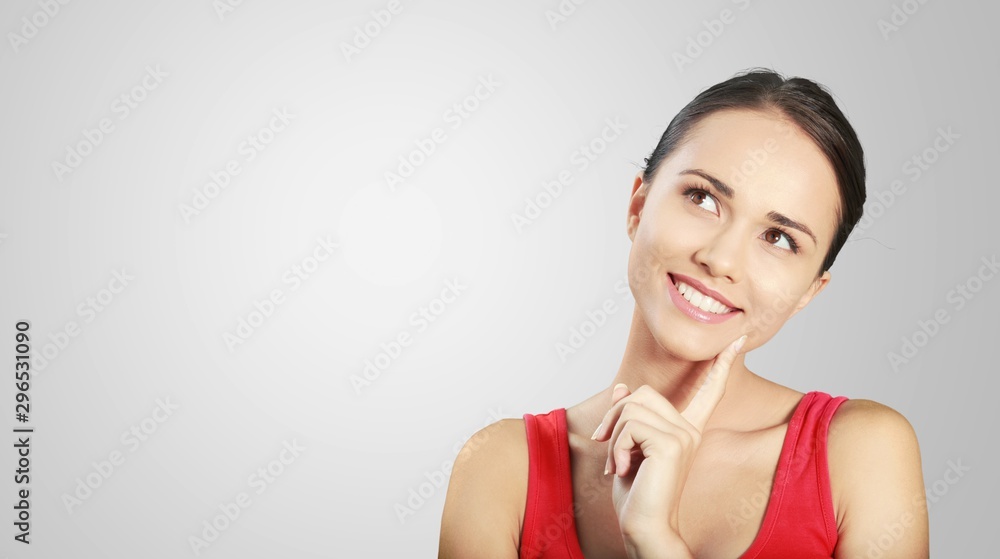 Adult woman thinking on grey background Adult woman thinking on grey background