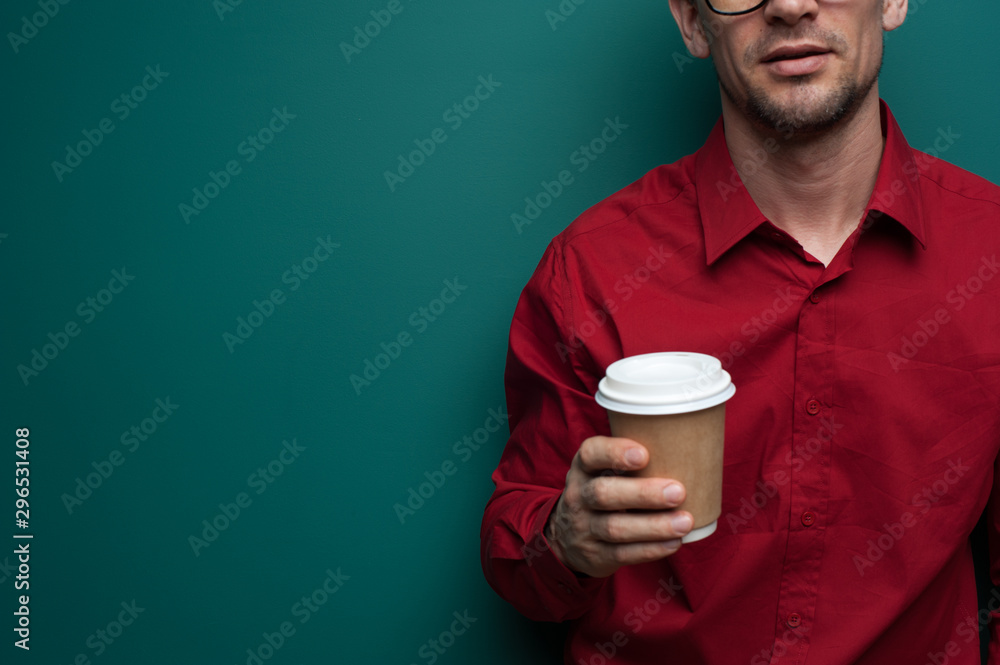 Close-up - young man holding a glass of coffee Close-up - young man holding a glass of coffee