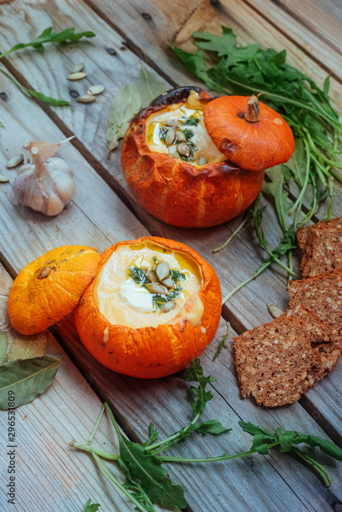 Pumpkin soup served in a small pumpkins. autumn dish. Still life, top view, Pumpkin soup served in a small pumpkins. autumn dish. Still life, top view,