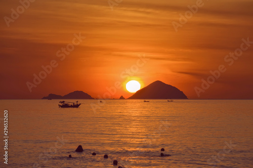 South China Sea at sunset  with silhouettes of fishermen in boats