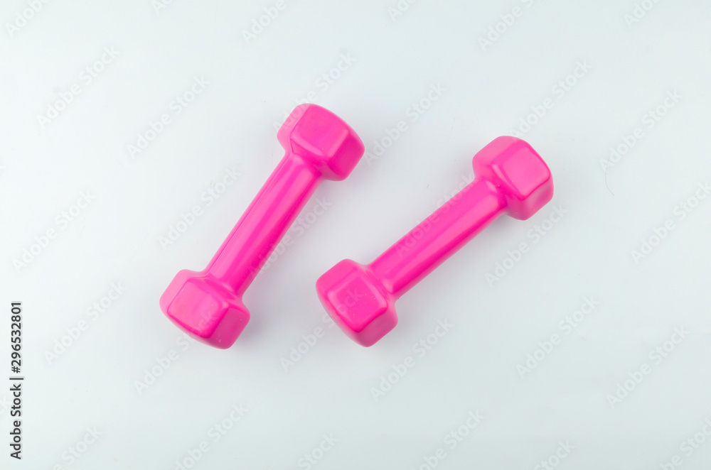 Two pink dumbbells isolated on white background. Two pink dumbbells isolated on white background.