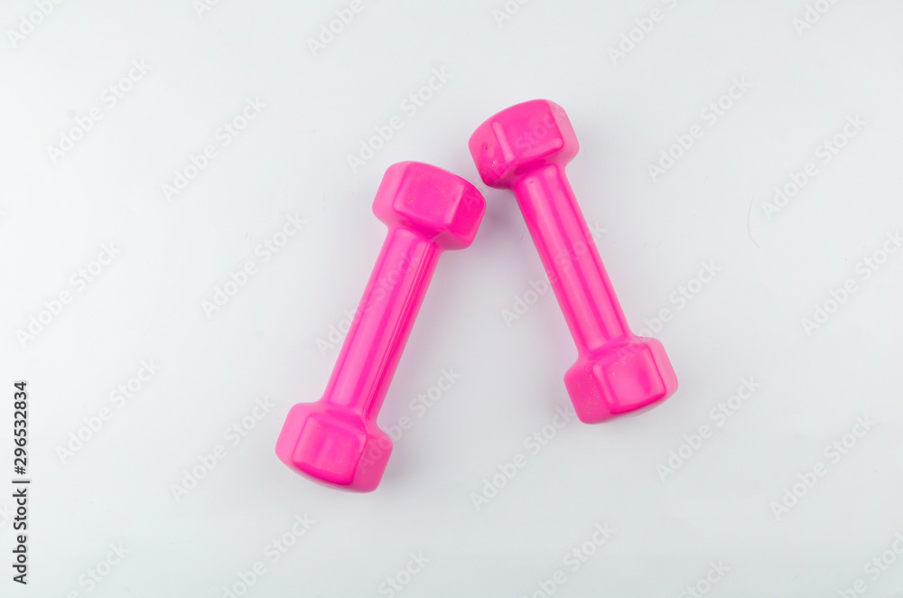 Two pink dumbbells isolated on white background. Two pink dumbbells isolated on white background.