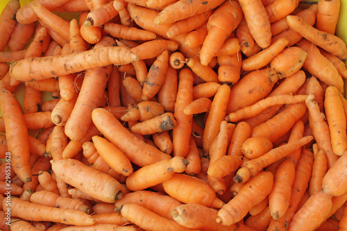 Fresh organic carrots with dirt. Carrot full frame picture. Carrots pattern. Orange food background. 
