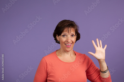 iddle Age Woman holding up five fingers