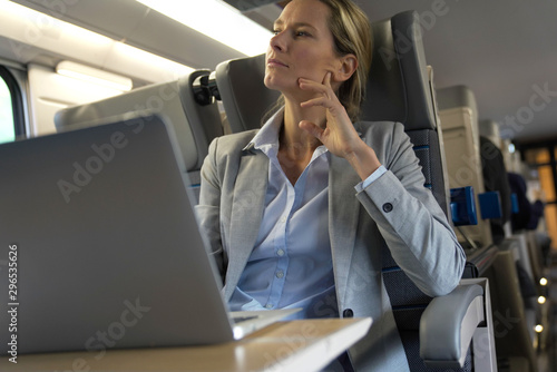 Wallpaper Mural businesswoman working on a train in business class Torontodigital.ca
